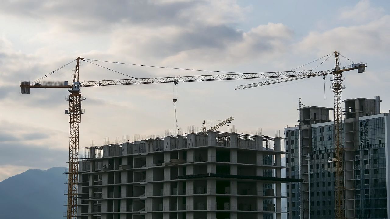 Tower cranes and buildings under construction on the skyline