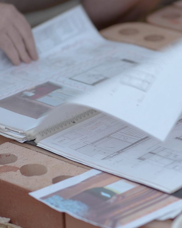 Construction drawings being leafed through on site
