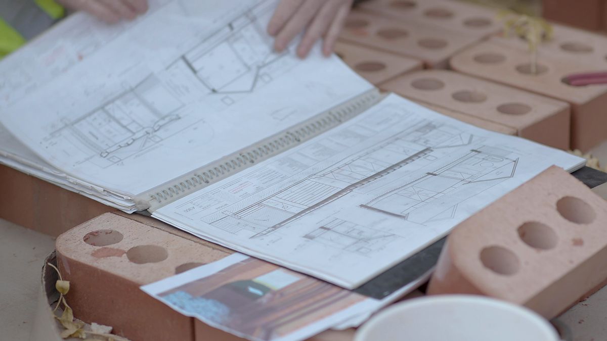 Construction drawings and quotes laid out on site
