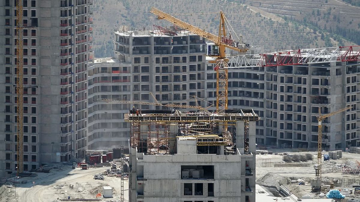 Residential towers under construction with a crane